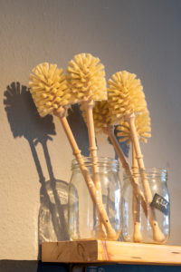 Toilet brushes are in glasses in an unpacked shop. Toilet brushes are in glasses in an unpacked shop.
